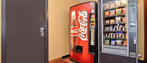 A vending machine with snacks and a Coca-Cola dispenser.