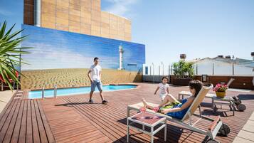 Guests can enjoy a refreshing swim in the pool surrounded by a deck and lounge chairs.