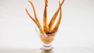 A clear glass bowl containing several golden-brown pastries.