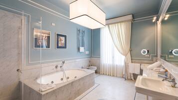 A modern bathroom with a freestanding bathtub, a large mirror, and a vanity with a sink.