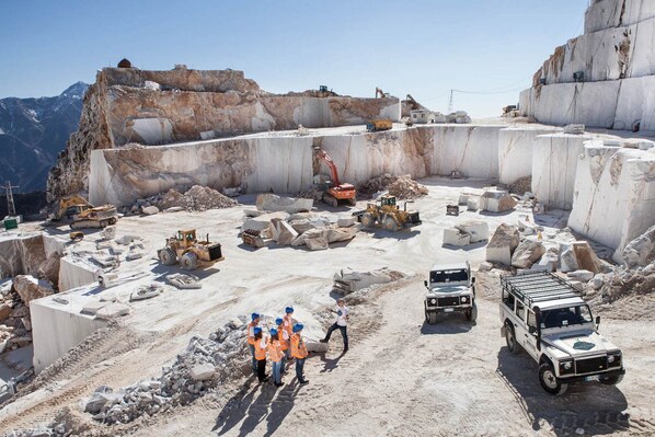 A construction site with large concrete blocks, excavators, and construction vehicles.