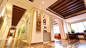 A spacious lobby with a marble floor, wooden ceiling beams, and a reception desk. - Delmon International Hotel (Manama)