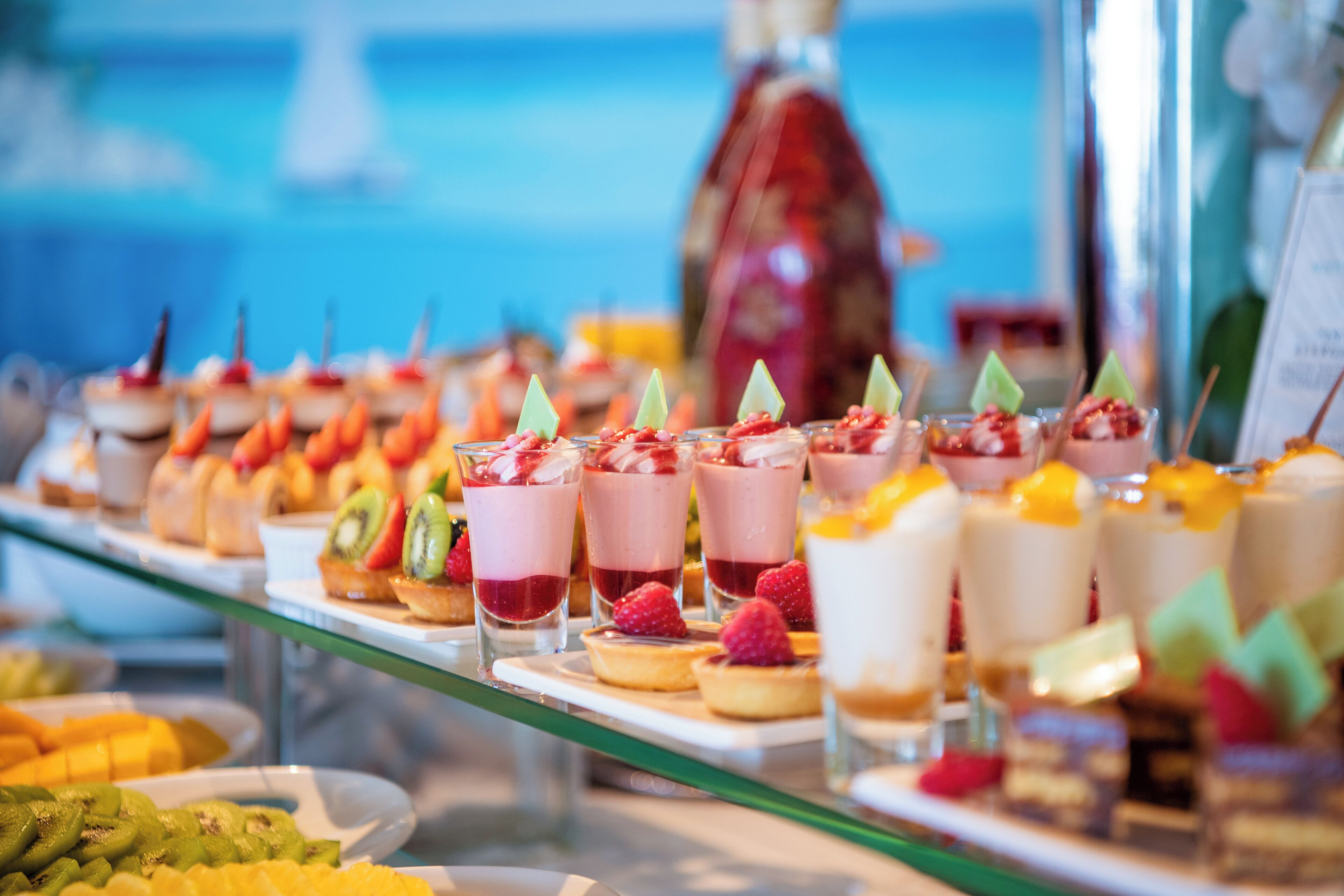 A buffet with various desserts and fruits.