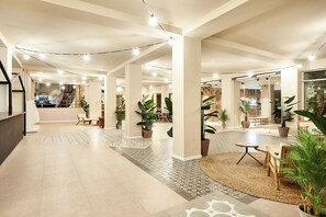 A spacious lobby with a modern design, featuring a central seating area, potted plants, and a staircase leading to upper floors. - tent Torremolinos (Torremolinos)