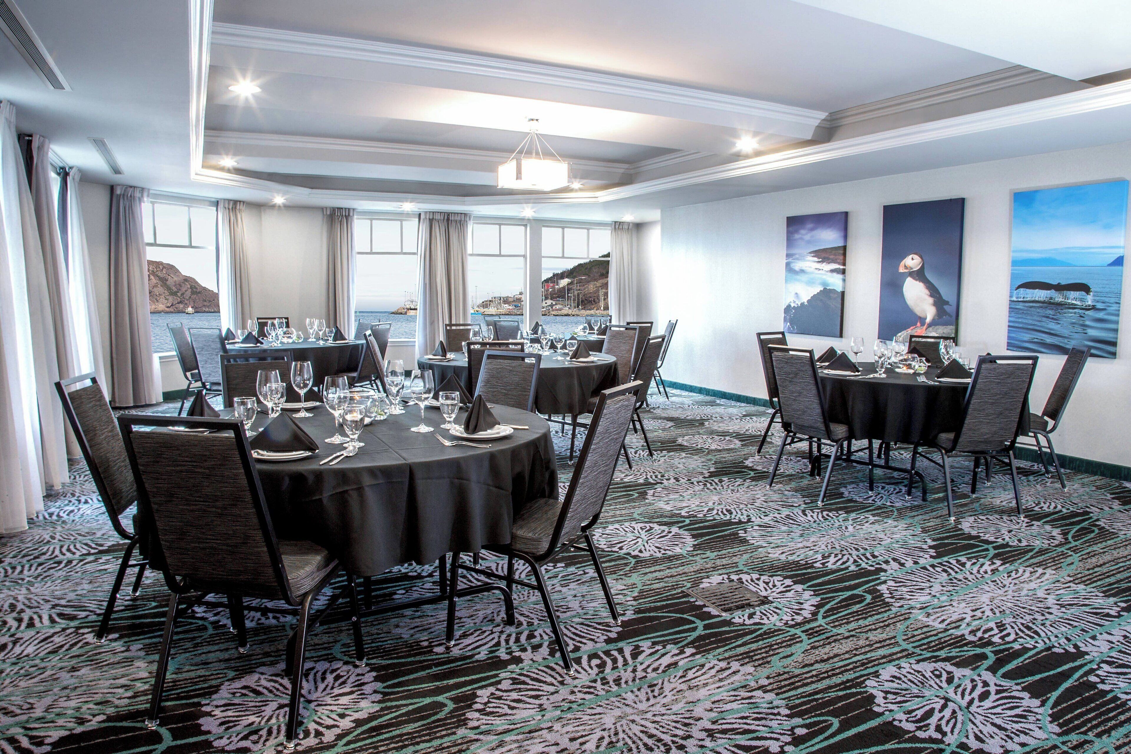 A dining area with round tables, chairs, and a patterned carpet.