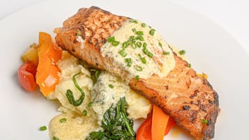 A plate with grilled salmon, mashed potatoes, and steamed vegetables.