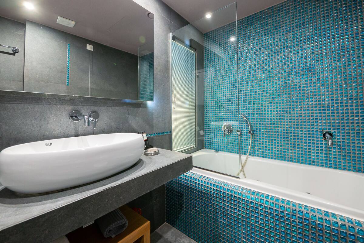 poseidon coco-mat suite front sea view | bathroom | shower, free toiletries, hair dryer, slippers
