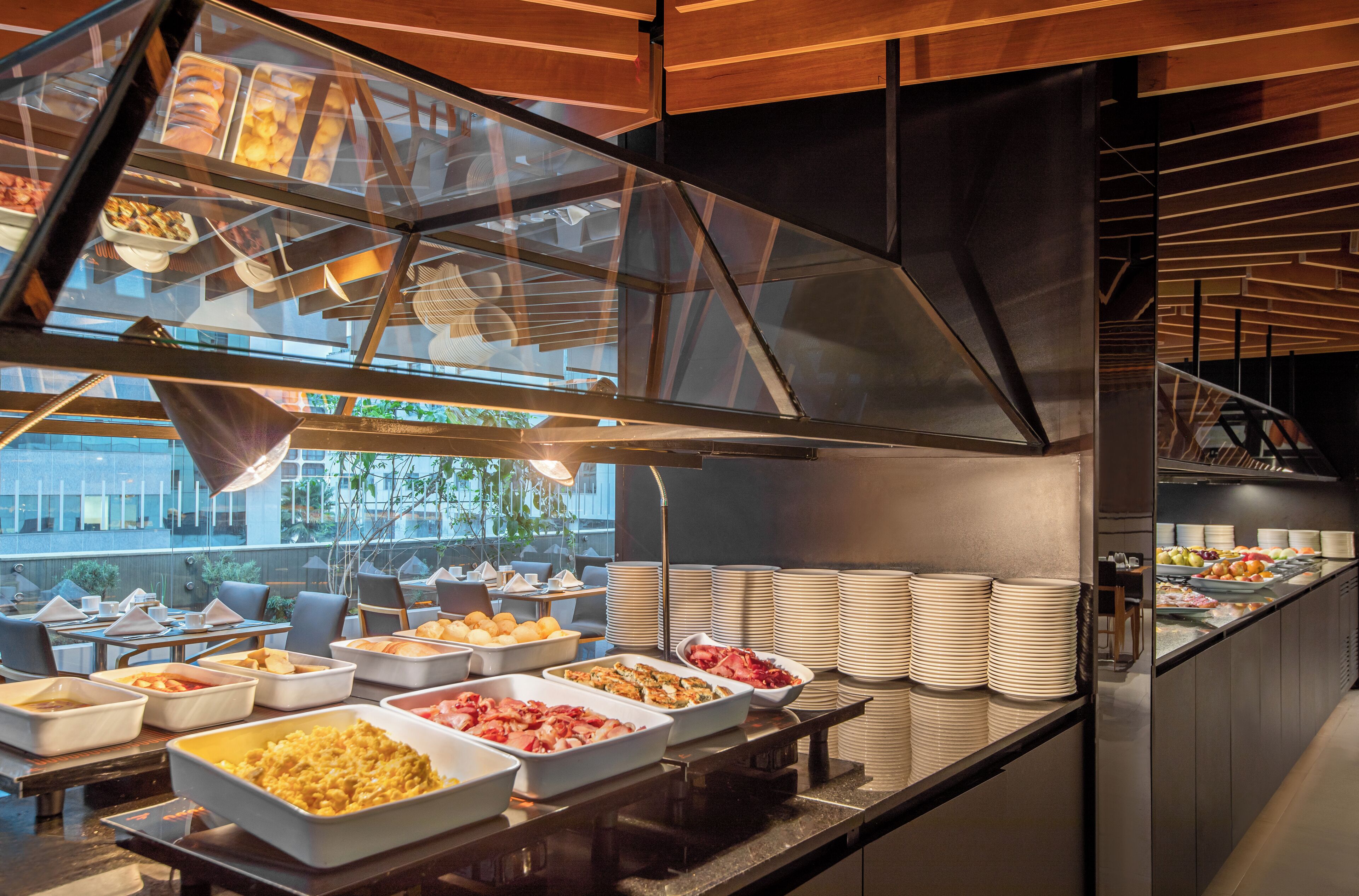 A buffet with various food items and a glass enclosure.