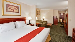 A hotel room with a large bed, a desk, a chair, a sofa, and a television. - Fairfield by Marriott Inn & Suites New Milford (New Milford)