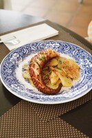 A plate of food on a table with a woven placemat.