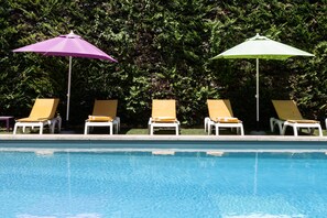 Seasonal outdoor pool, open 8:00 AM to 8:00 PM, pool umbrellas