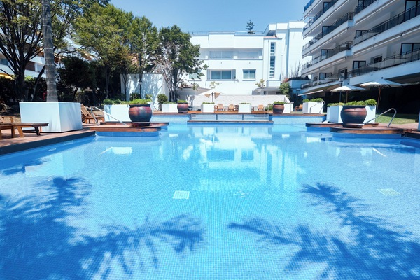 Seasonal outdoor pool, open 9:00 AM to 10:00 PM, pool umbrellas