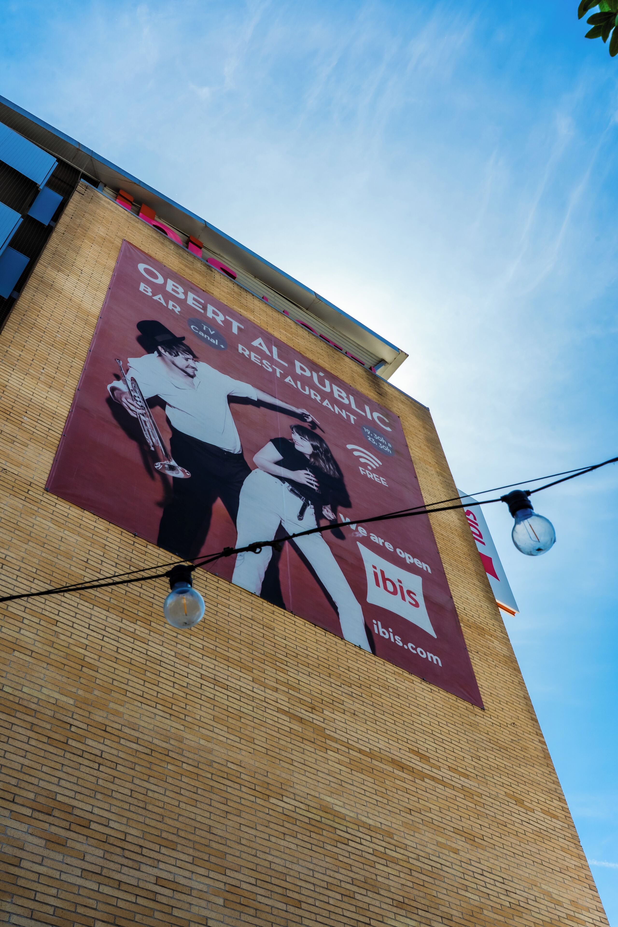 A building with a large billboard advertising a public art grant.