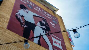 A building with a large billboard advertising a public art grant.
