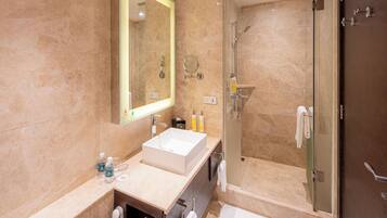 A modern bathroom with a large mirror, a sink, a shower, and a bathtub.