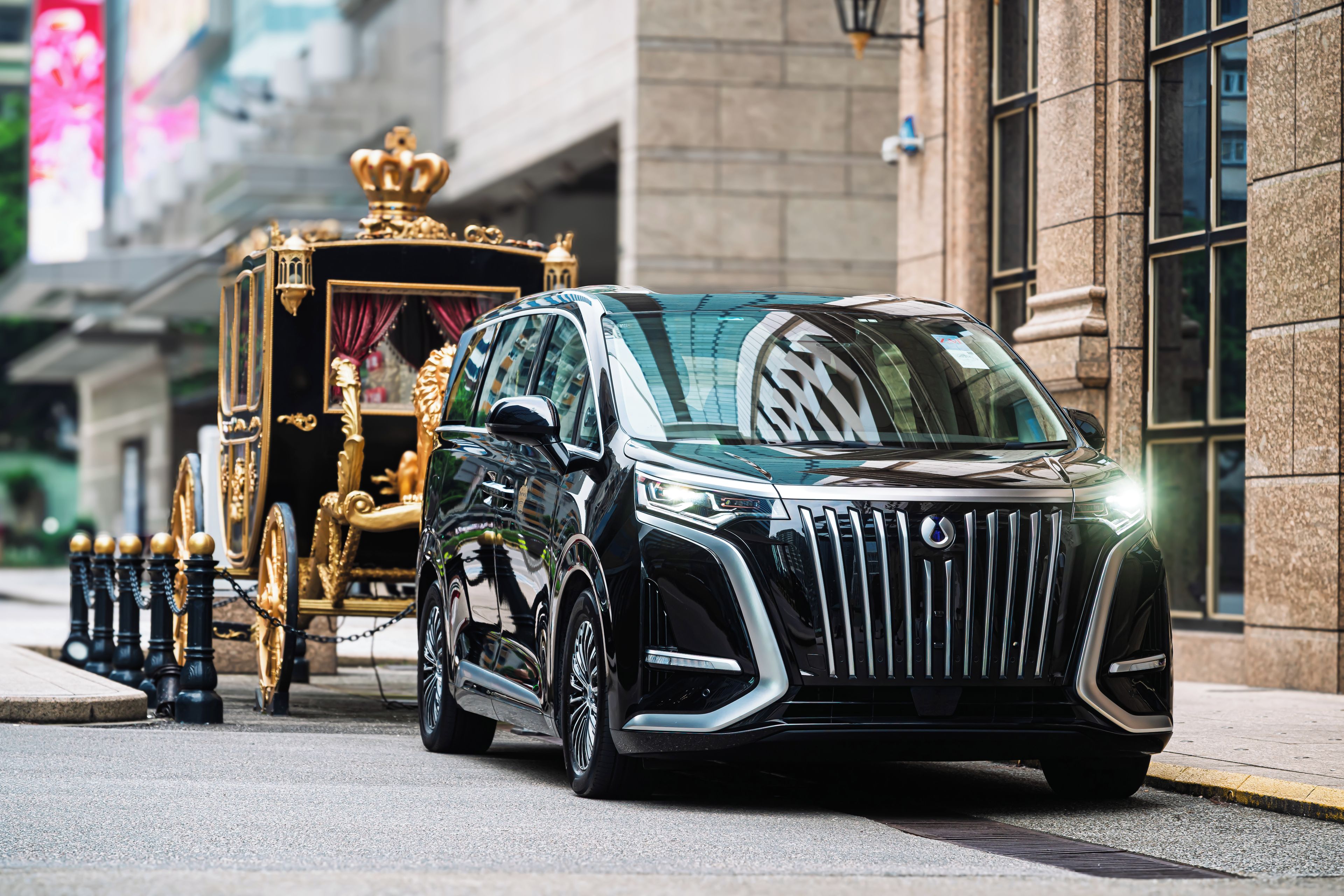 A black luxury SUV with a distinctive grille and emblem, parked on a city street.