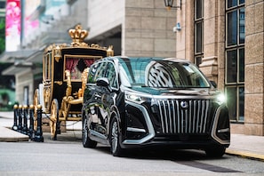A black luxury SUV with a distinctive grille and emblem, parked on a city street. - Grand Emperor Hotel  (Macau)