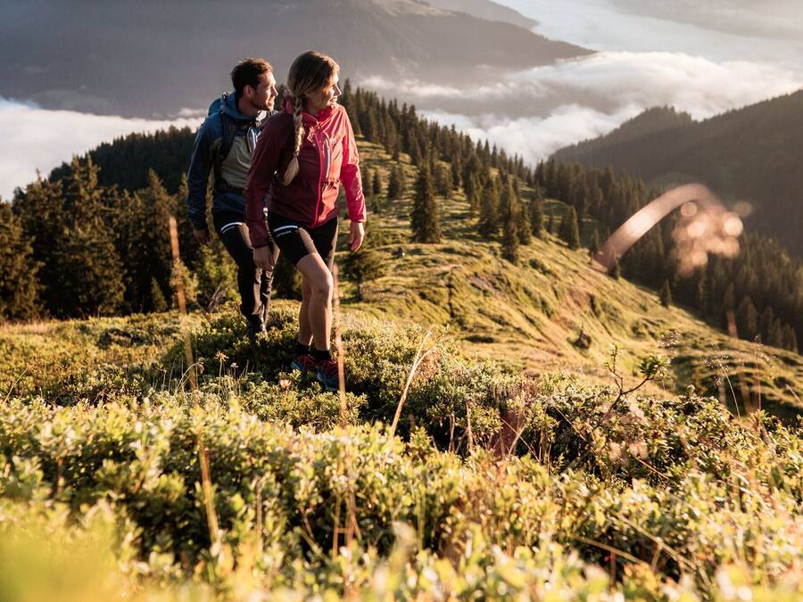 A mountainous landscape with hikers.