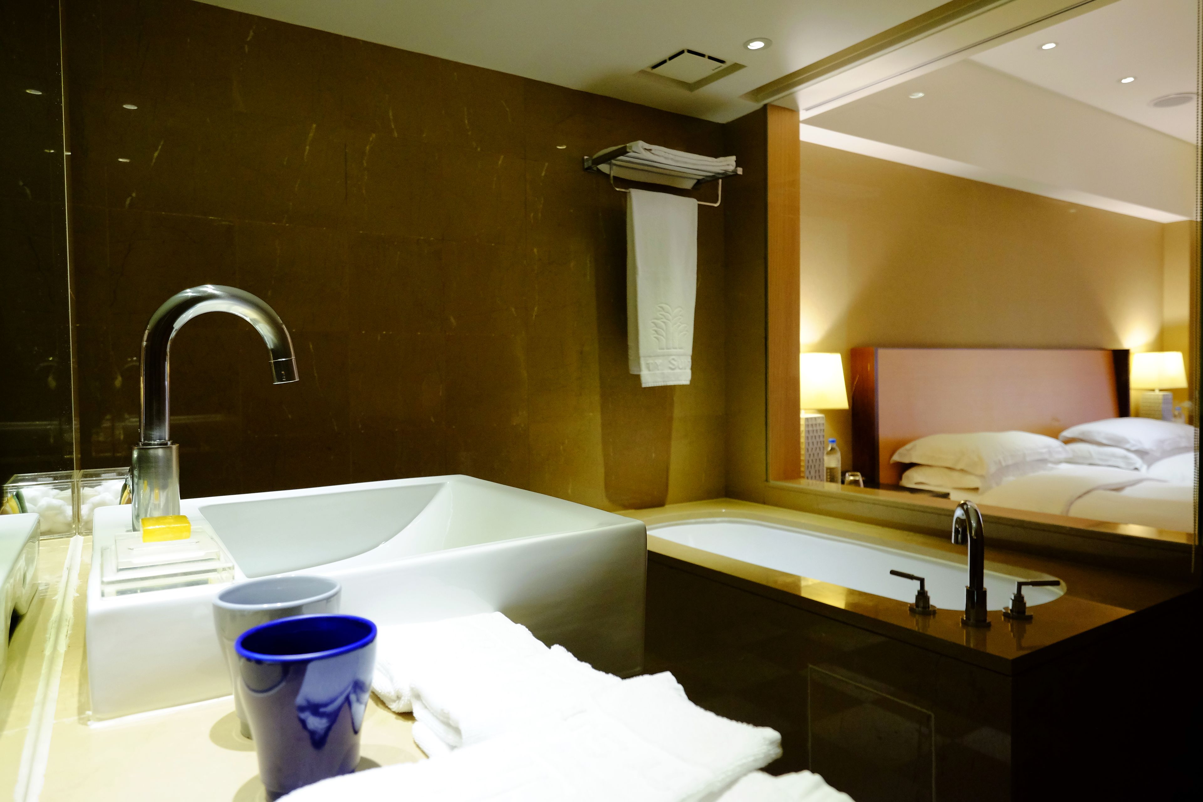 deep-soaking bathtub, rainfall showerhead, hair dryer, towels