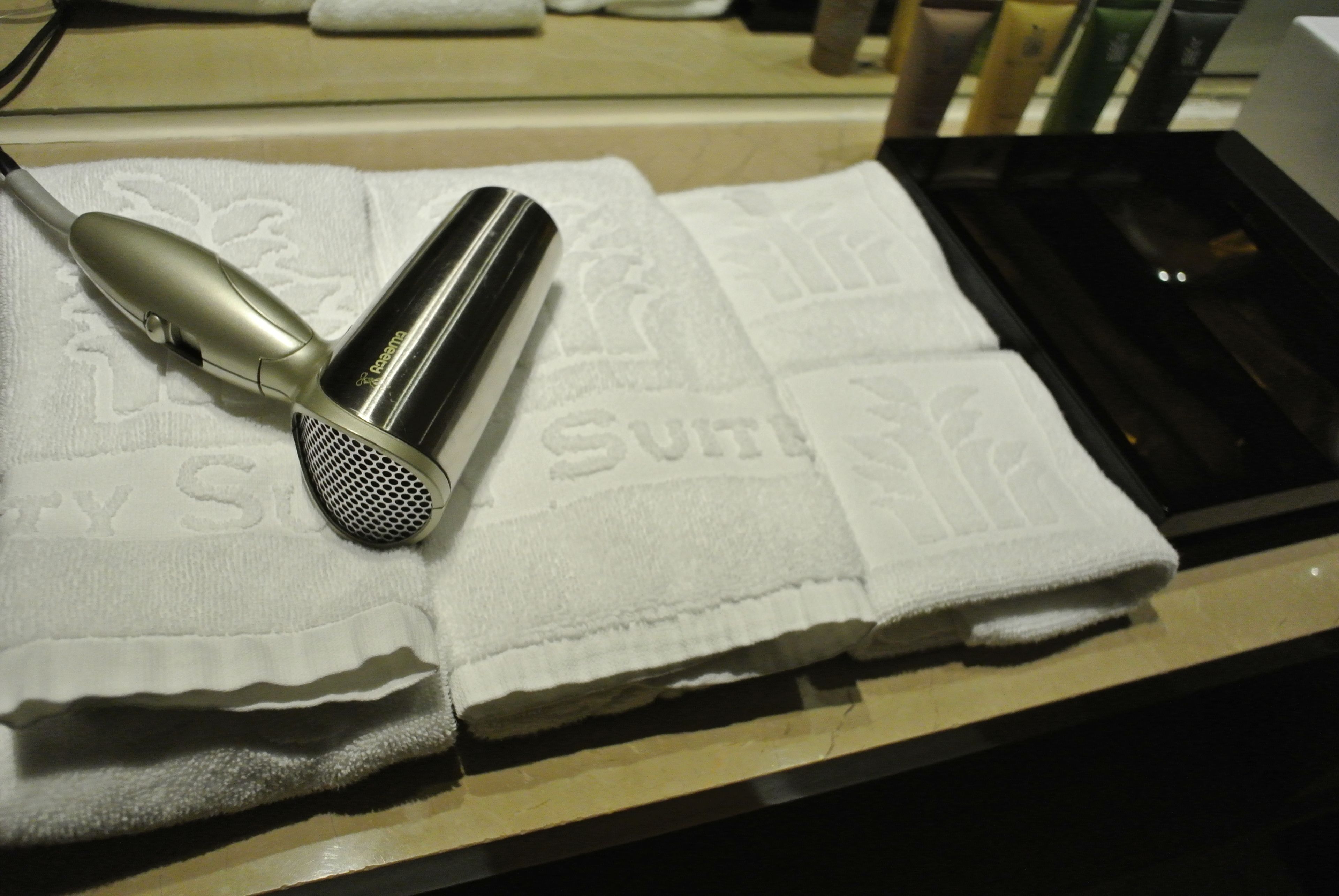 deep-soaking bathtub, rainfall showerhead, hair dryer, towels