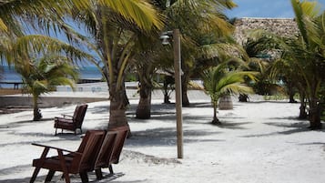 On the beach, white sand, free beach cabanas, beach umbrellas