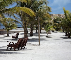 On the beach, white sand, free beach cabanas, beach umbrellas