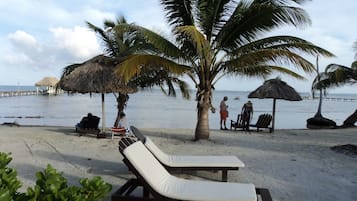 On the beach, white sand, free beach cabanas, beach umbrellas