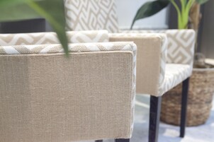 A close-up of a textured fabric chair with a geometric pattern.