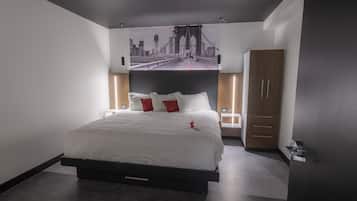 A modern bedroom with a large bed, a cityscape mural on the wall, and a wooden wardrobe.