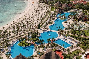 A resort with multiple swimming pools, palm trees, and beach access. - Barceló Maya Colonial - All Inclusive (Xpu-Ha)