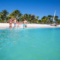 On the beach, white sand, sun-loungers, beach towels