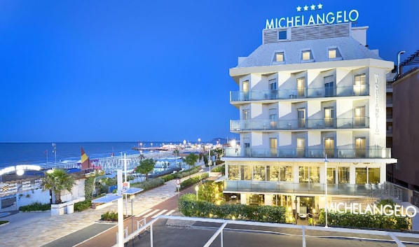 A multi-story hotel named Michelangelo with a view of the beach and marina.