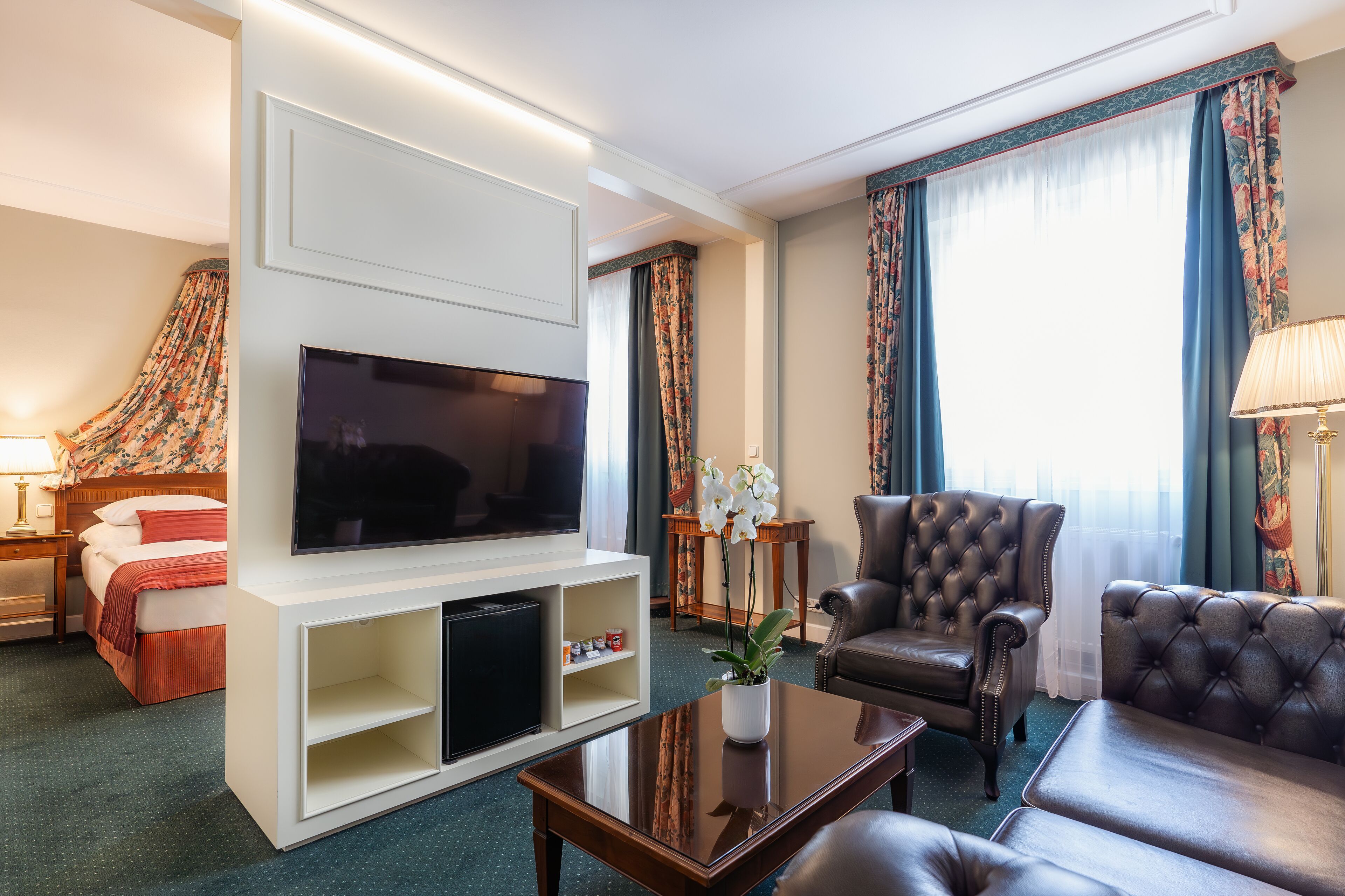 deluxe double room | living area | 24-inch lcd tv with satellite channels, tv