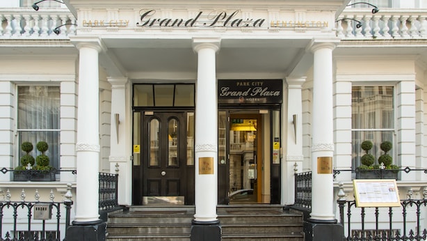 The entrance of the Grand Plaza Hotel with a classic facade, large columns, and a black door. - The Park City Grand Plaza Kensington (London)