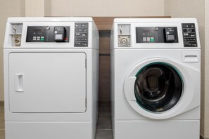 Two front-loading washing machines side by side in a laundry room.