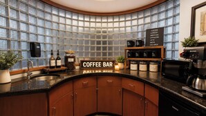 A modern kitchen with a coffee bar, built-in shelves, and a central island. - Apple Tree Inn and Suites (Independence)