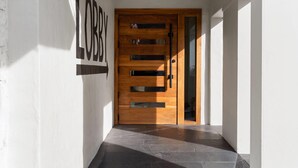 A wooden door with a glass panel, a 'LOBBY' sign, and a tiled floor. - The Hotel Pendleton, Trademark Collection by Wyndham (Pendleton)