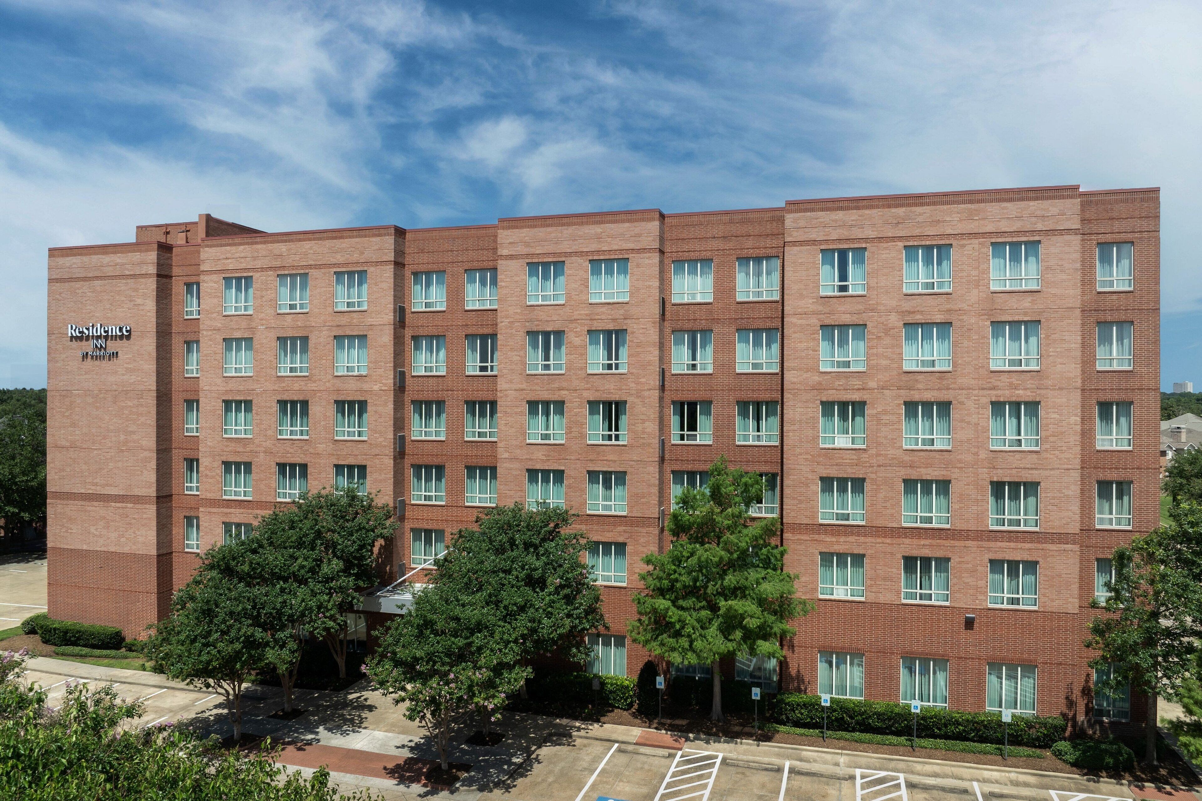 A multi-story brick building with a sign reading "Residence Inn."
