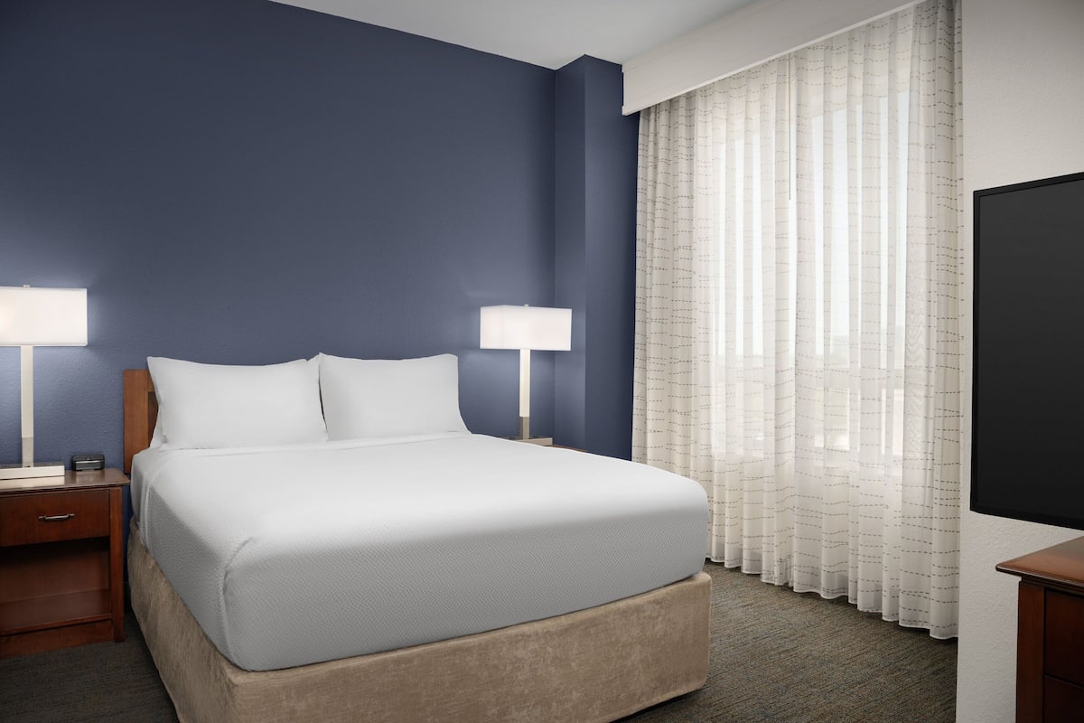 Premium bedding, desk, laptop workspace, blackout curtains