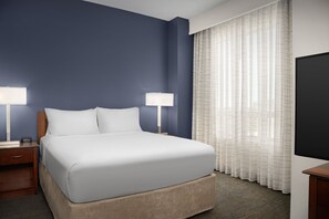 Premium bedding, desk, laptop workspace, blackout drapes