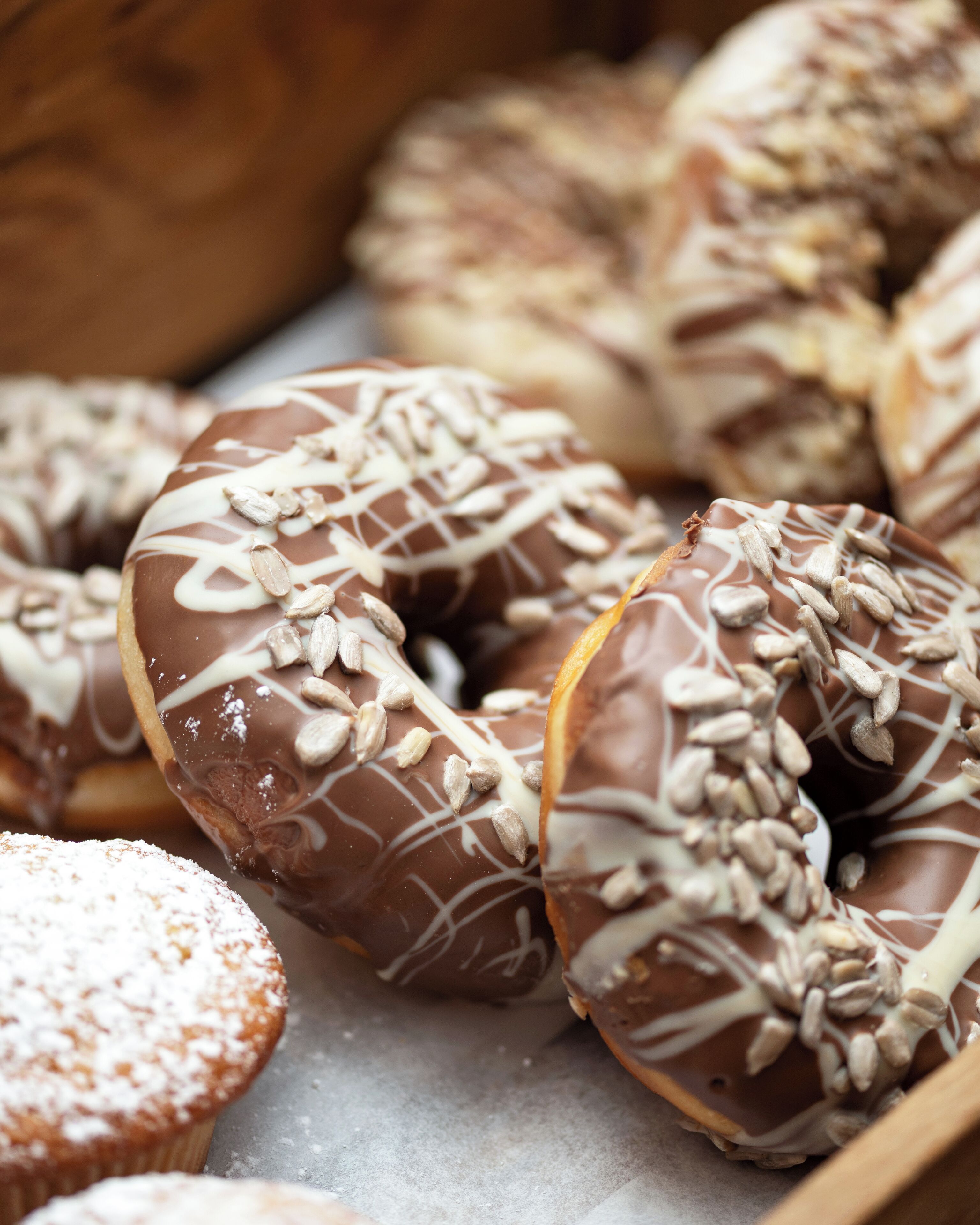 A variety of donuts with chocolate icing and toppings.
