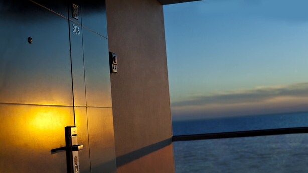 A modern elevator with a number plate, a door handle, and a light. - Renaissance by Sulo (Aktau)