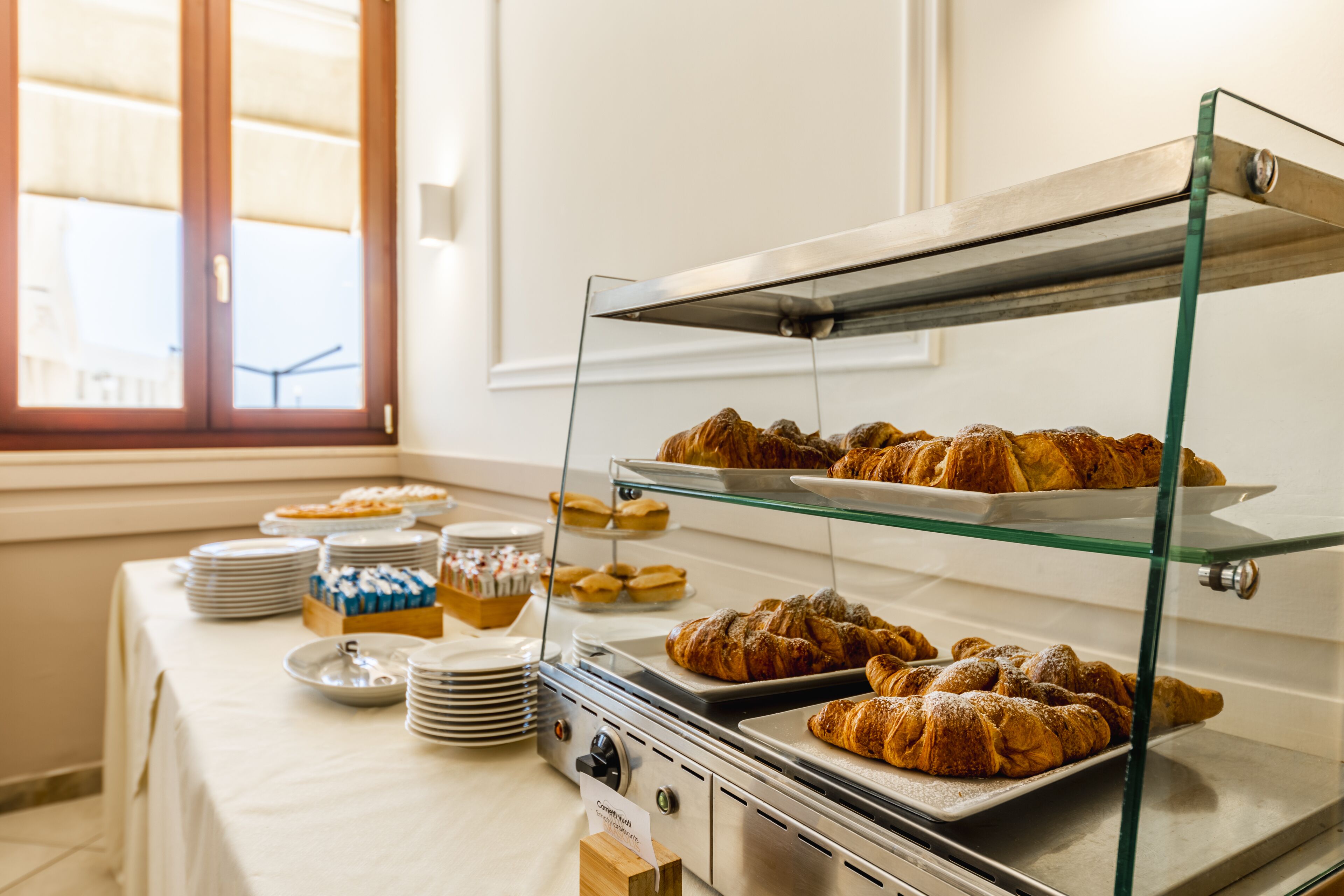 A buffet setup with various pastries and desserts on display.