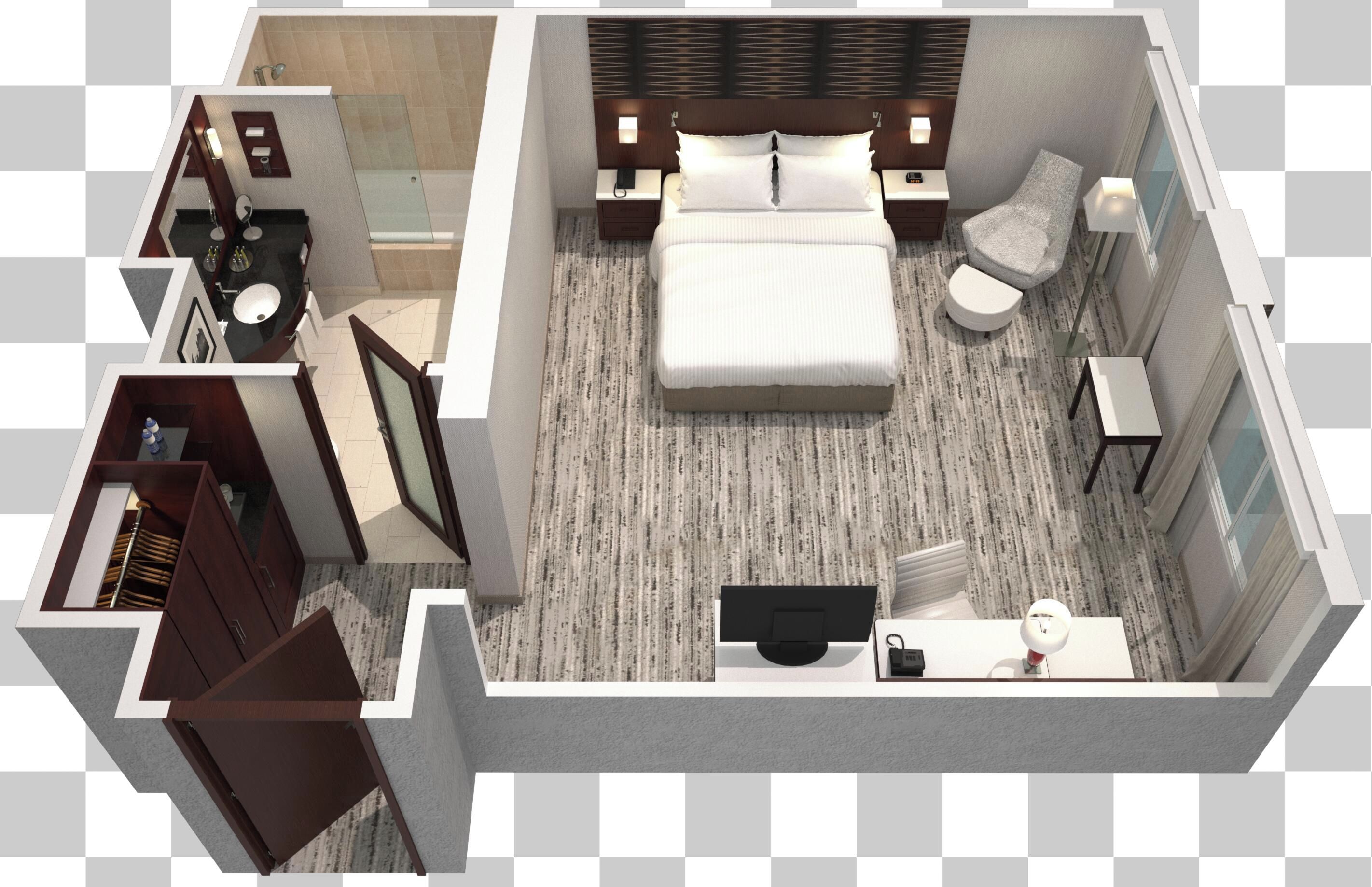 Una habitación de hotel con cama, sofá, escritorio, baño y armario.