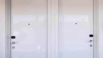 Two white doors with a simple design, a small lock, and a handle on the left door.