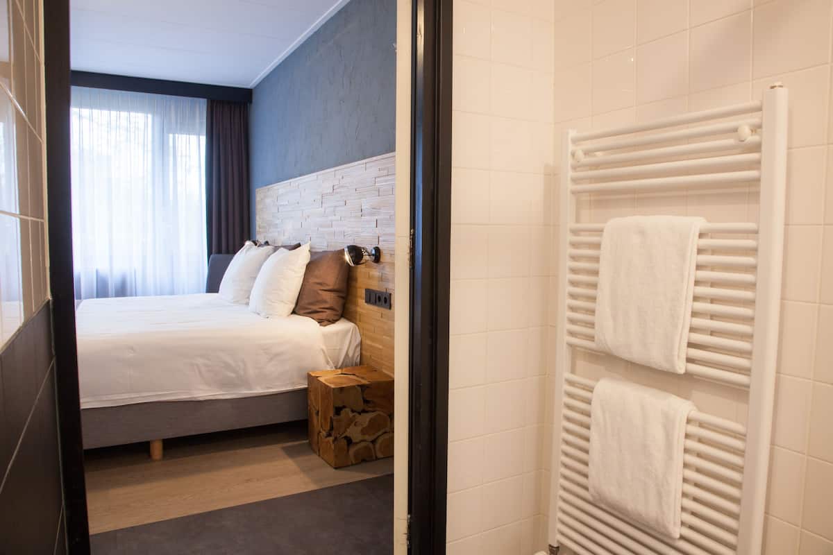 family room | desk, blackout curtains, iron/ironing board, cots/infant beds