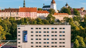 A hotel with a modern facade, multiple floors, and a prominent sign. - Go Hotel Shnelli (Tallinn)