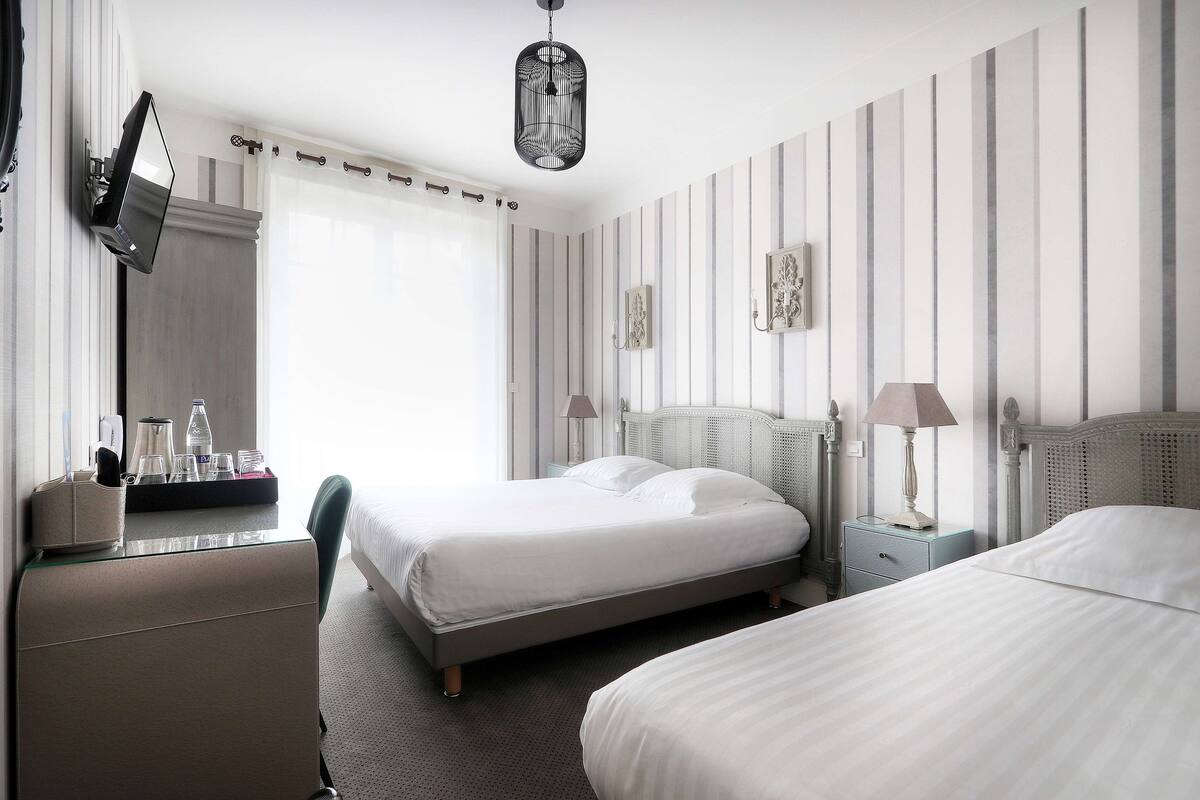 standard room, multiple beds, bathtub | in-room safe, desk, soundproofing, iron/ironing board