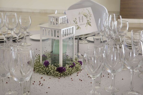 A table set with clear wine glasses and a white lantern centerpiece. - NH Gran Hotel Casino Extremadura (Badajoz)