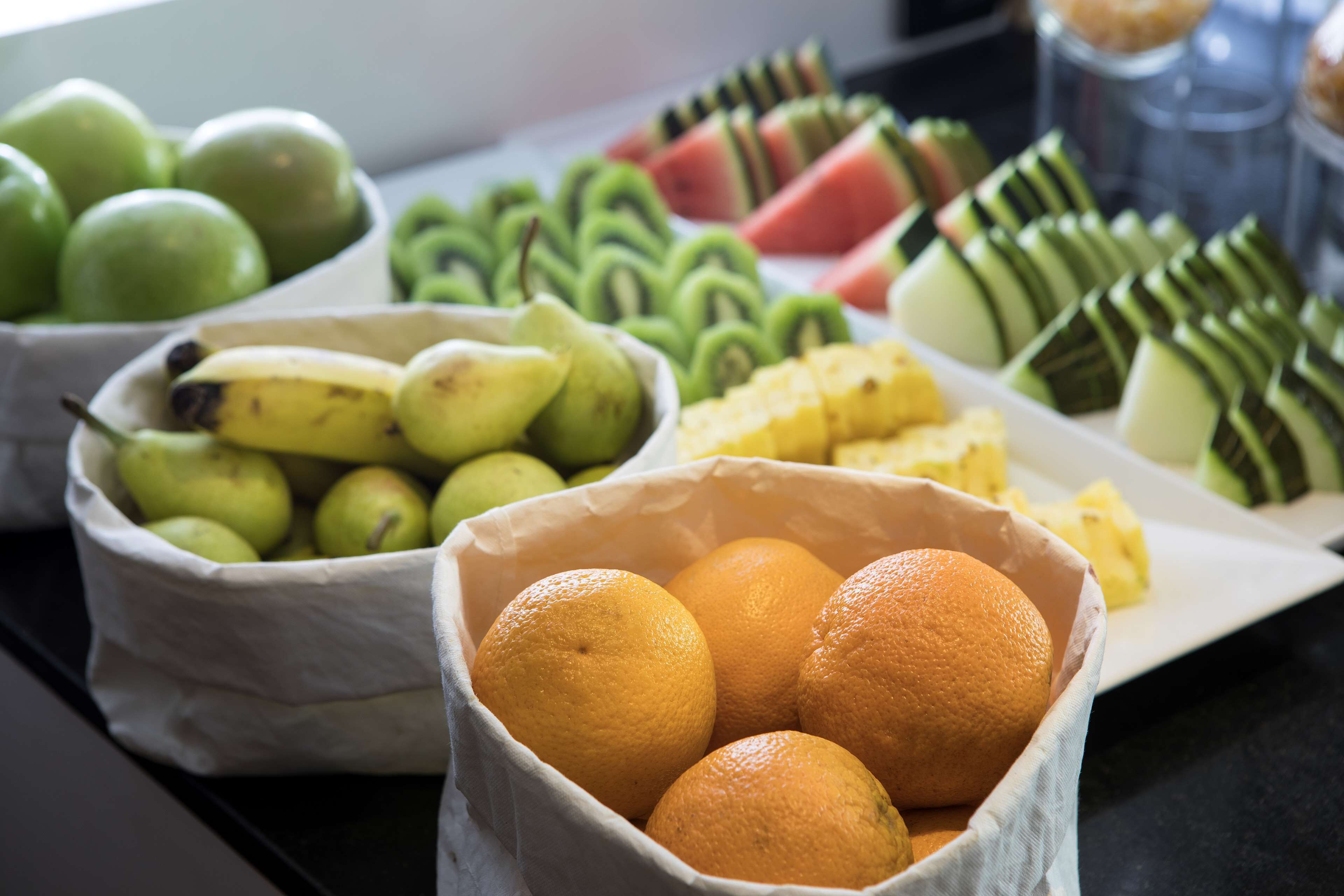 A table with various fruits in baskets.